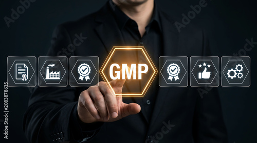 Businessman pointing at GMP Good Manufacturing Practice icon on virtual screen