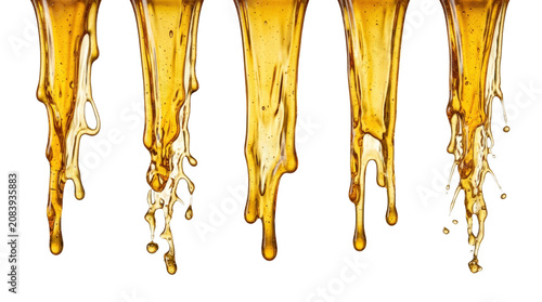 Golden liquid dripping in slow motion.