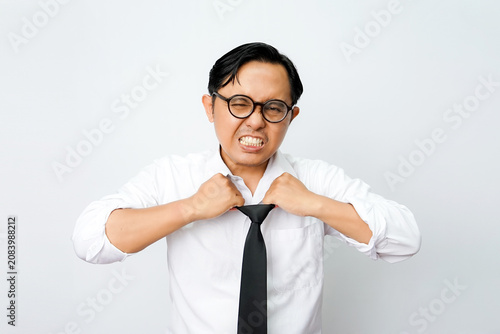 Konstfotografi Stressed Asian businessman loosening tie in frustration