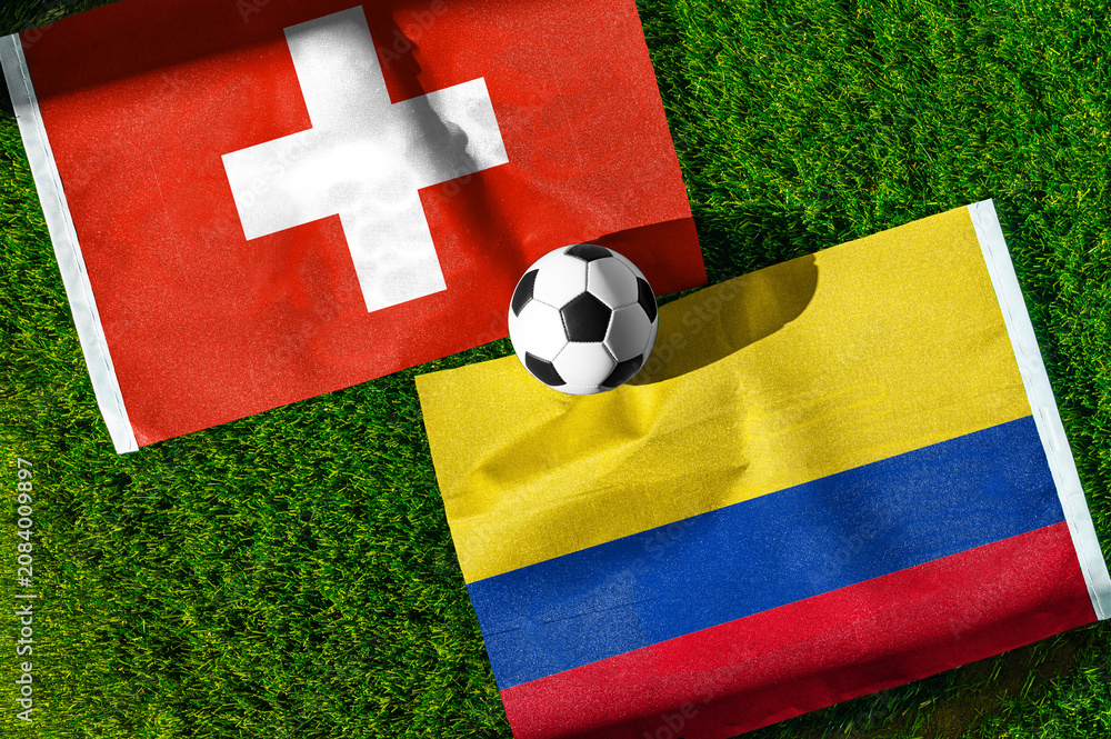 Fototapeta premium Switzerland vs Colombia, Round of 16, national flags before international football match, football on green grass with stadium in the background, BC Place, Vancouver, Canada, July 7, 2026