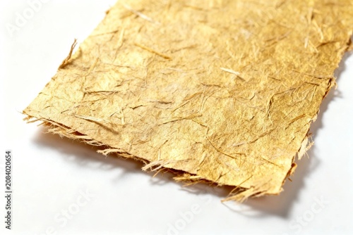 Close-up of textured golden handmade paper