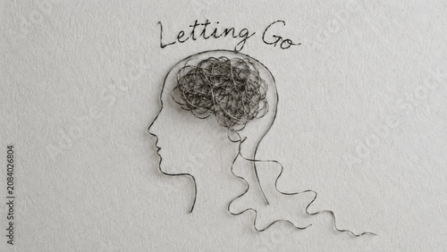 Wire thread human head profile silhouette, loose strand forming tangled brain, handwritten letting go text above, gray paper background, mental wellness concept, calm release mood