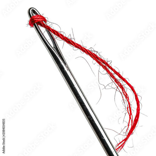 A close-up shot of a sewing needle with red thread against a black background.