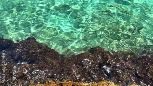 Crystal clear turquoise sea water and scenic rocky coast with sailing boats under a blue sky. summer vacation concept.