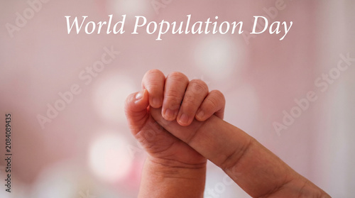 World Population Day Newborn Baby Hand Gripping Adult Finger Extreme Close Up Soft Pastel Blush Bokeh Background