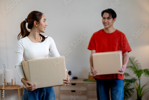 Excited Couple Opens Moving Boxes In Their New Apartment