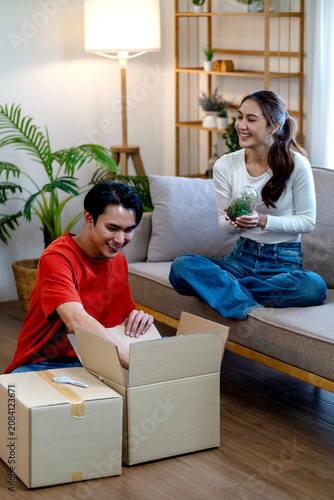 Young Couple Unboxes Belongings After Moving To New Home