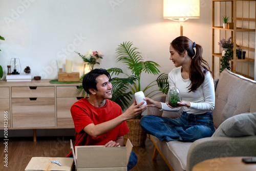 Couple Unboxes Items Together While Organizing New Apartment