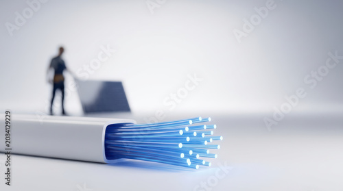 Fiber optic cable with glowing blue fiber optic cables minim and blurred technician in background