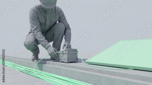 Fiber optic technician working on cable connection with fusion splicer device in industrial setting, focused on precise task