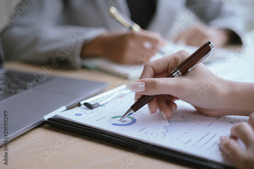 Business Professionals Reviewing Financial Reports and Performance Charts