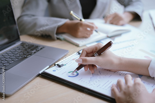 Business Professionals Reviewing Financial Reports and Performance Charts