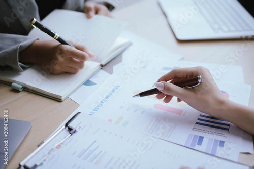 Business Professionals Reviewing Financial Reports and Performance Charts
