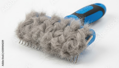 Pet fur remover brush covered with collected hair on white background  