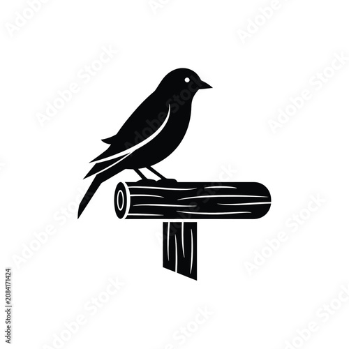 Black bird sitting on wooden log.