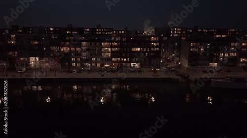 Apartment buildings by canal at night