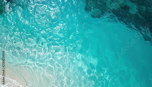 Aerial view of crystal clear turquoise ocean water ripples.