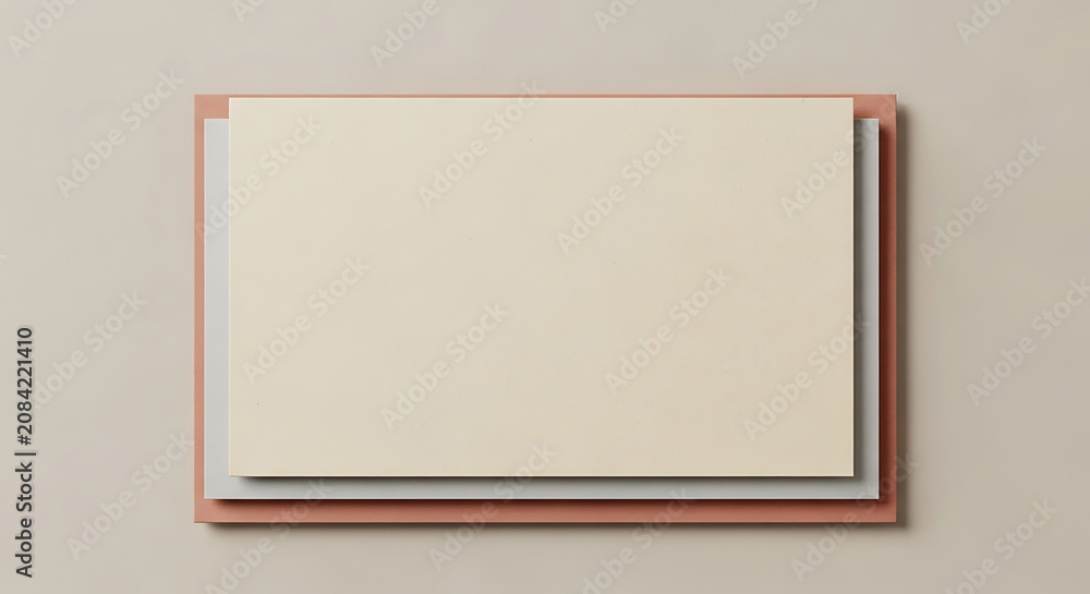 Fototapeta premium Stacked rectangular paper sheets in layers of beige, grey, and terracotta on a neutral background