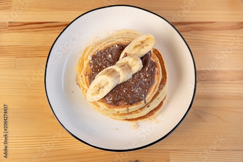 Fotografía Banana pancakes with chocolate topping top view
