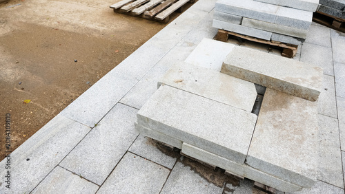 Fotografi Stacked concrete paving slabs on wooden pallets at construction site prepared fo