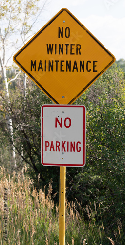 Photography no winter maintenance sign along an unpaved road in a mountainous area