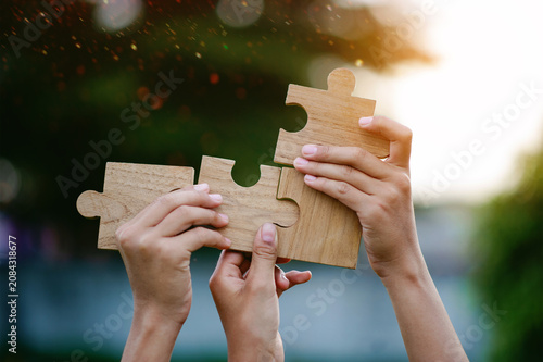 The jigsaw puzzle pieces that complete the unity and cooperation in teamwork, love and filling in the missing pieces.