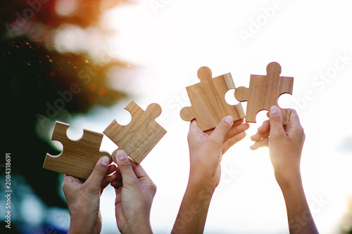 The jigsaw puzzle pieces that complete the unity and cooperation in teamwork, love and filling in the missing pieces.