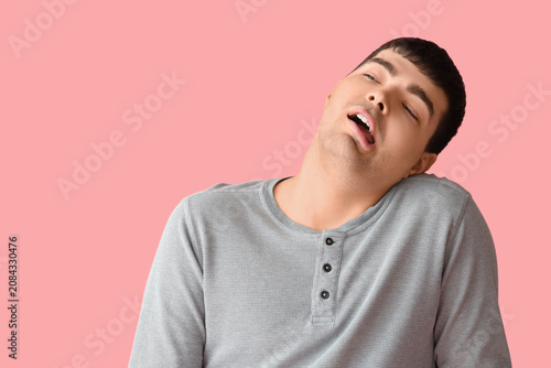 Young man on pink backgroun...