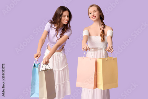 Happy young sisters with sh...