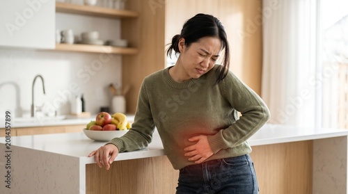 Asian woman with severe stomach pain