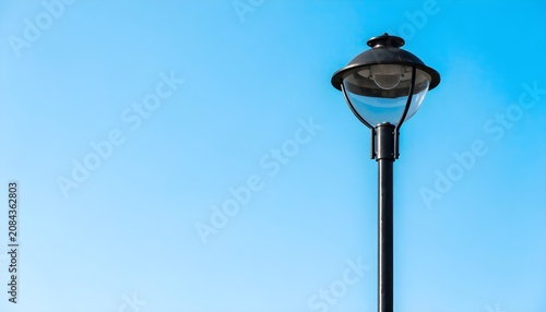 Classic Black Street Lamp Against Clear Blue Sky Minimalist Outdoor Scene