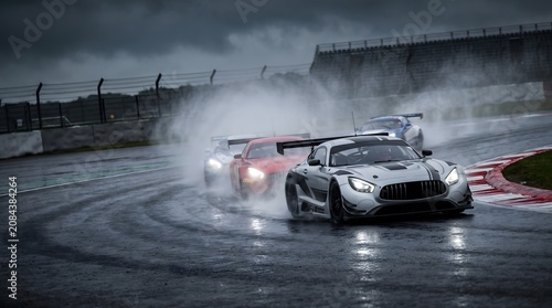 Race, Spray. Wet race motorsport racing cars spraying water at curve on asphalt circuit headed by Mercedes AMG
