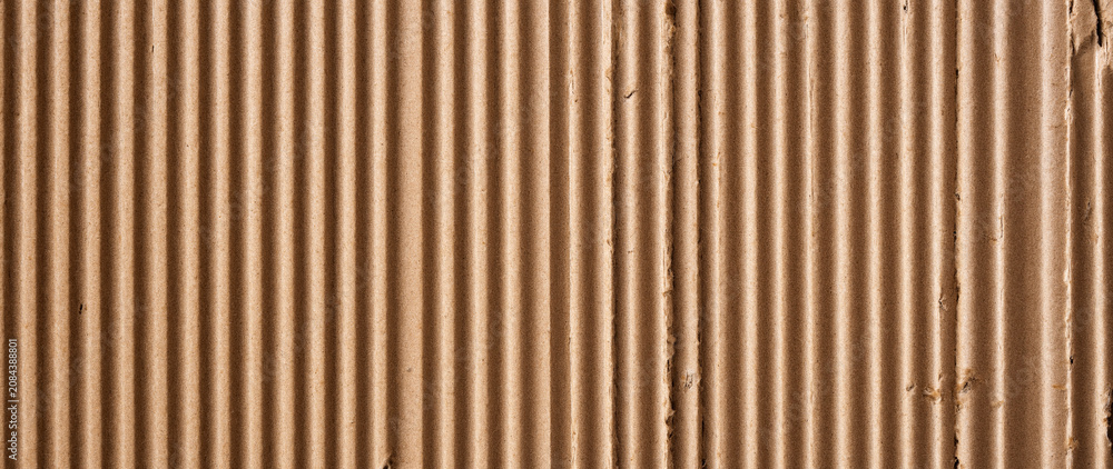 Fototapeta premium Natural Brown Corrugated Cardboard Texture Background with Vertical Ribbed Pattern, High Detail Rough Paper Surface for Sustainable Packaging Design, Minimalist Backdrop with Warm Earthy Tones