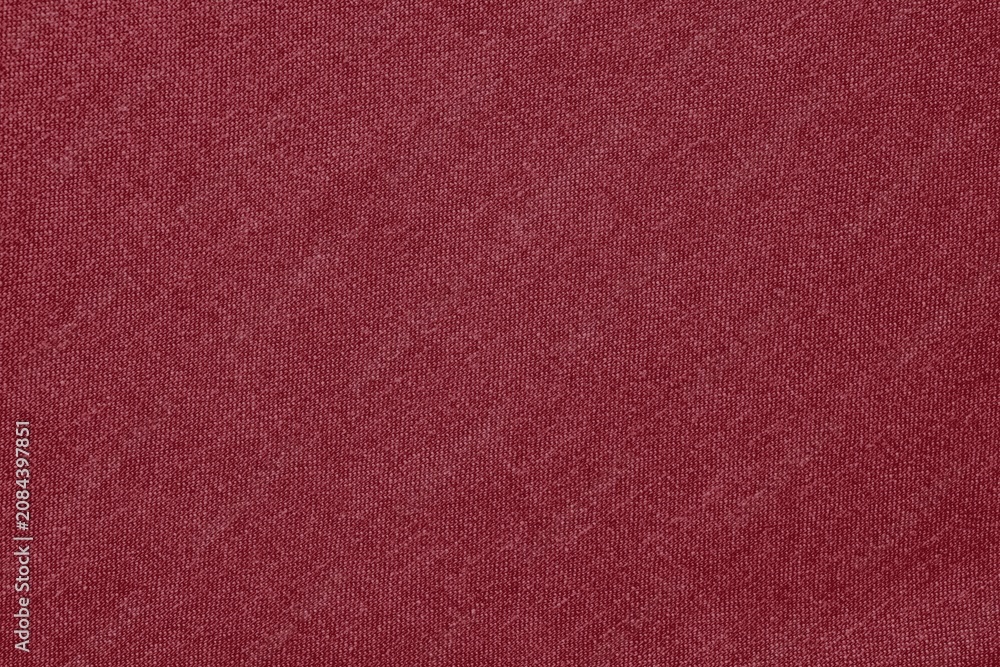 Fototapeta premium Maroon fabric texture background with a soft, woven appearance.