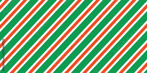 Christmas seamless pattern. Red and green diagonal stripes background. Candy cane repeating decoration wallpaper. Winter holiday lines backdrop. Xmas peppermint present wrapping print design. Vector
