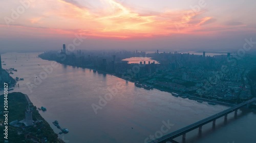 Aerial Timelapse Panorama of Wuhan City Skyline at Sunrise, Yangtze River and Wuhan Yangtze River Bridge at Dawn, Hubei China