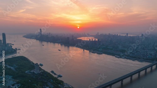 Aerial Timelapse Panorama of Wuhan City Skyline at Sunrise, Yangtze River and Wuhan Yangtze River Bridge at Dawn, Hubei China