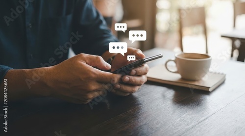 Person using smartphone with chat bubble icons