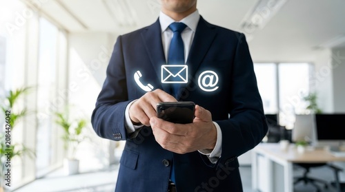 Businessman using smartphone with contact icons