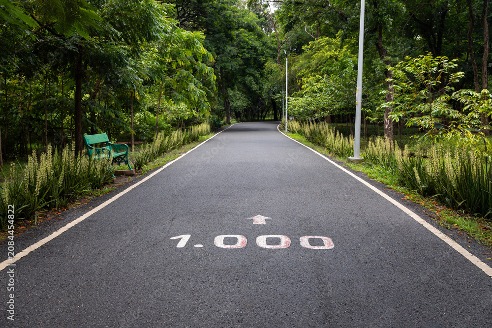 Fototapeta premium Empty jogging track with one thousand meters marker in a fitness park