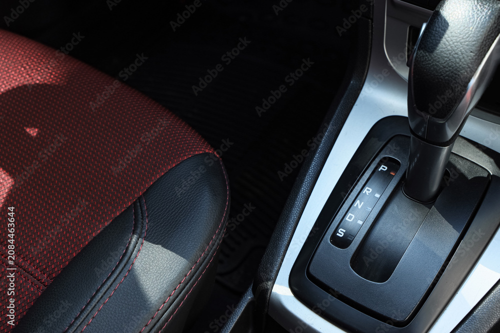 Obraz premium close-up of automatic car gear shift and red car seat