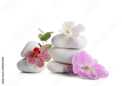 Stacked white spa stones with orchids and eucalyptus leaves