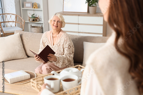 Senior woman reading book w...