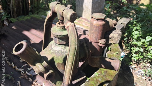 Vintage Rusty Hand Water Pump in Rural Village