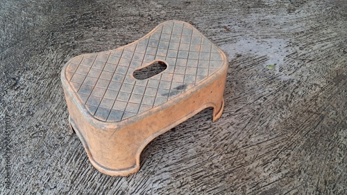 Small Plastic Step Stool on Concrete Floor