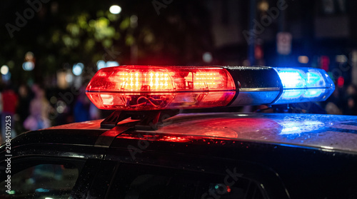 Red and Blue Emergency Vehicle Light Bar Flashing at Night on a Police Car