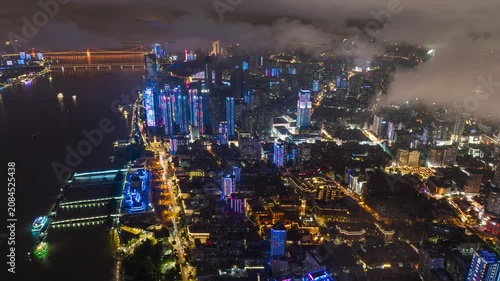 Aerial Timelapse of Wuhan Central Business District Night Cityscape, Skyscrapers Illuminated With Floating Clouds Over Wuhan Downtown, Hubei China