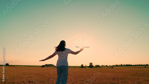 Foto Child girl plays with toy airplane