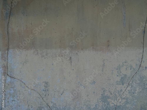 Cuadro en lienzo A close-up view of a cracked and weathered concrete wall with visible damage