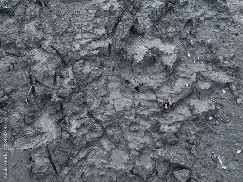 Tableau sur toile A close-up view of a rugged, cracked, and dry mud surface with rough terrain and natural texture